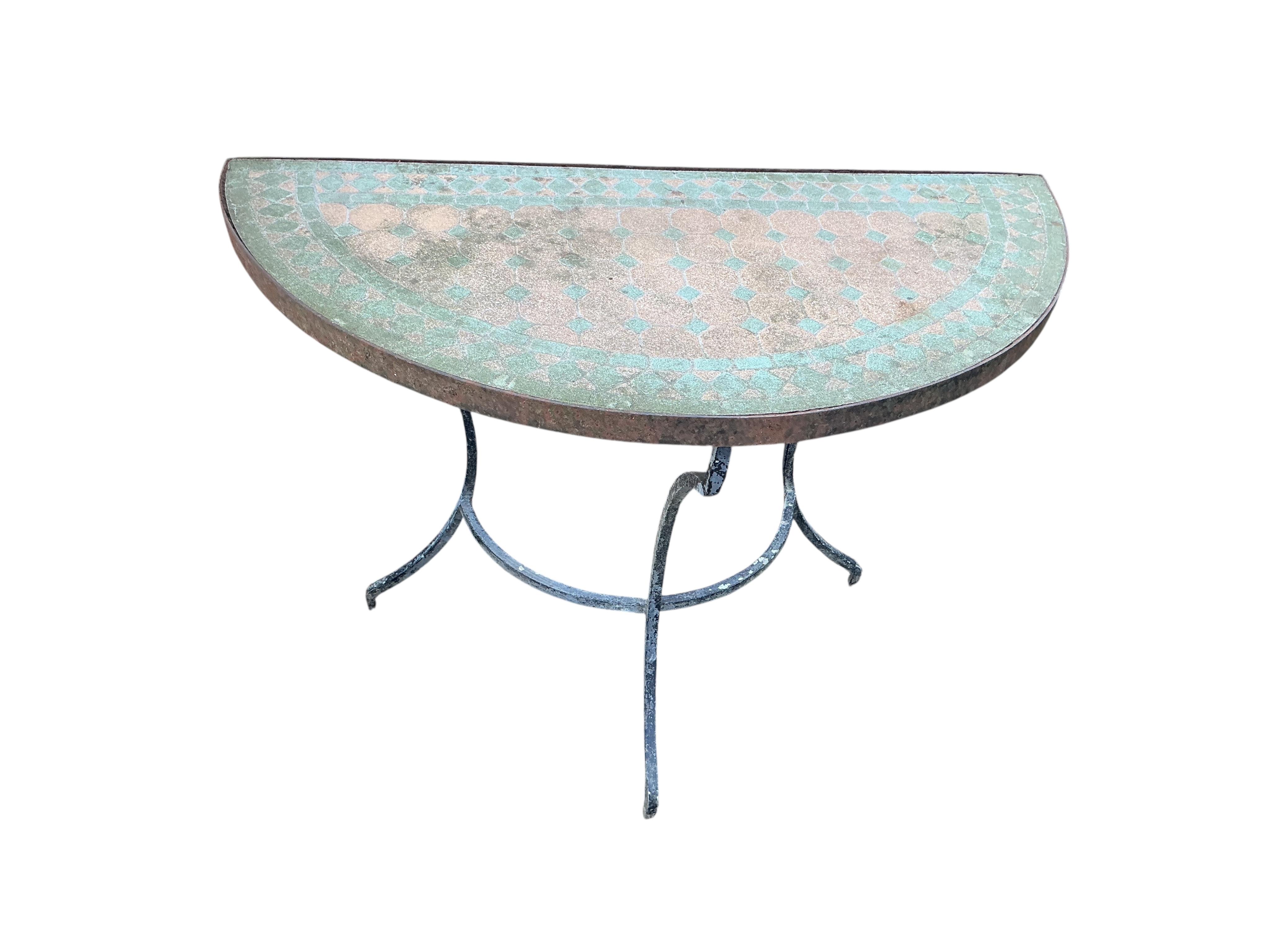 A mosaic topped demi-lune wrought iron garden table, width 96cm and a circular metal folding table with two chairs (requiring new bolts)